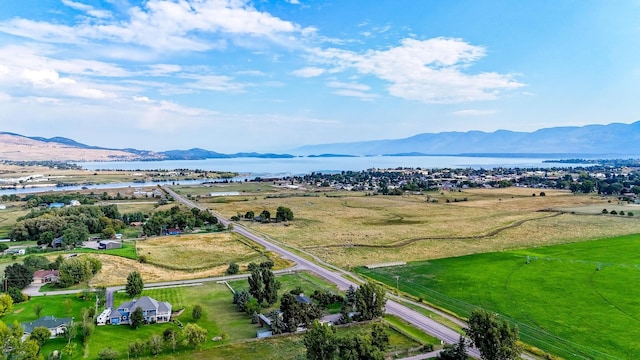 aerial view featuring a water and mountain view and a rural view