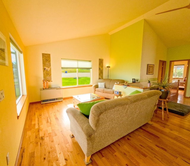 living room with lofted ceiling and light hardwood / wood-style floors