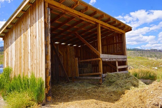 view of stable with a rural view