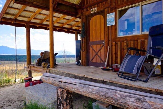 misc room featuring lofted ceiling, a rural view, and a mountain view