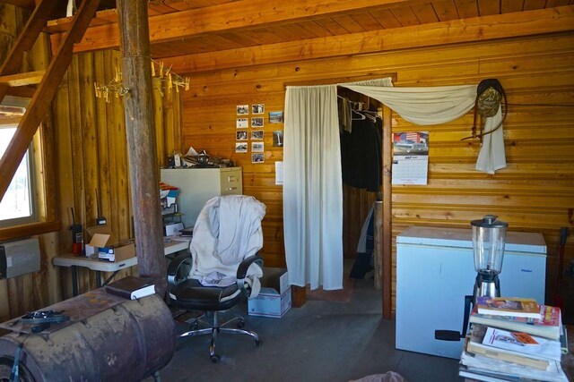 office area with wood walls, wood ceiling, and beamed ceiling