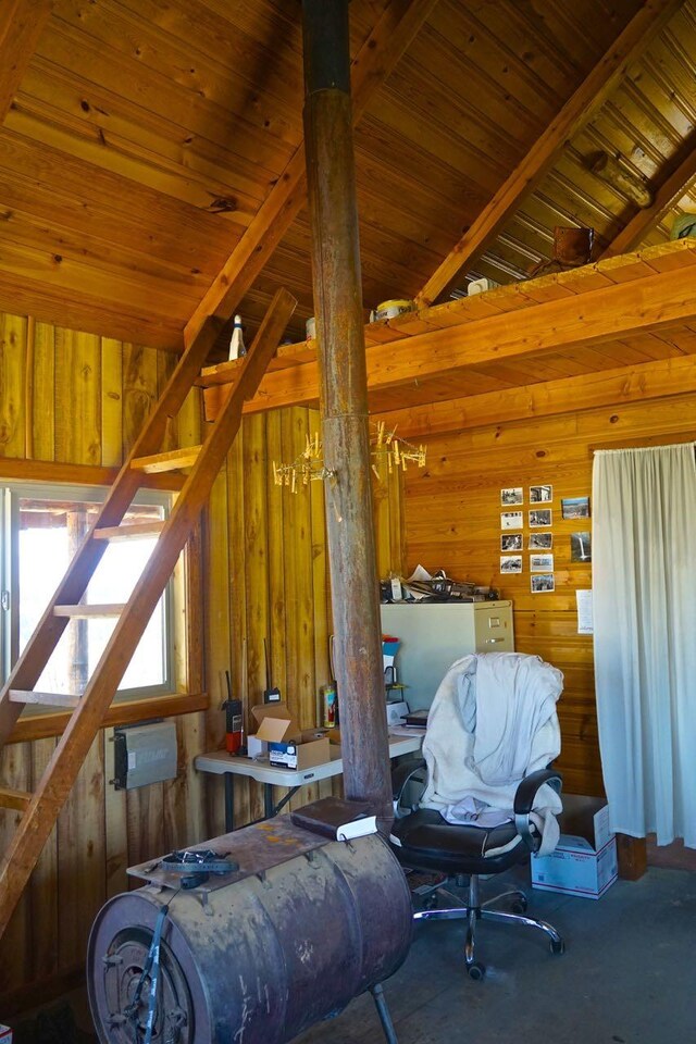 interior space with wood ceiling, wood walls, and vaulted ceiling with beams