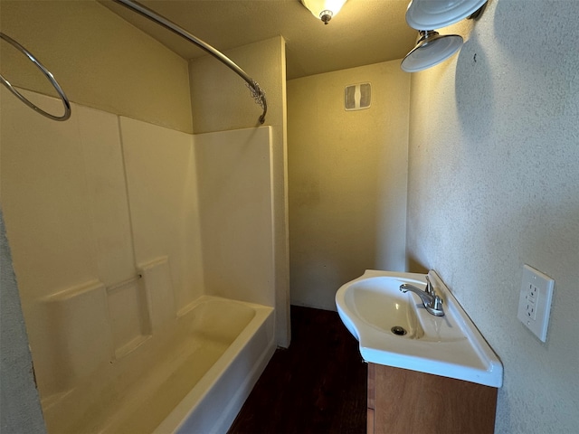 bathroom featuring vanity, shower / bath combination, and hardwood / wood-style floors