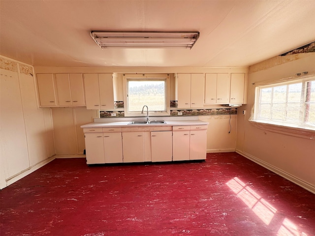 kitchen featuring white cabinetry and sink