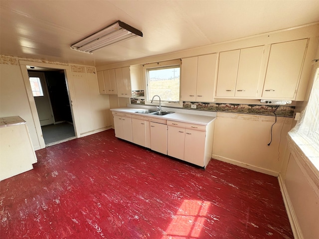 kitchen featuring white cabinets and sink