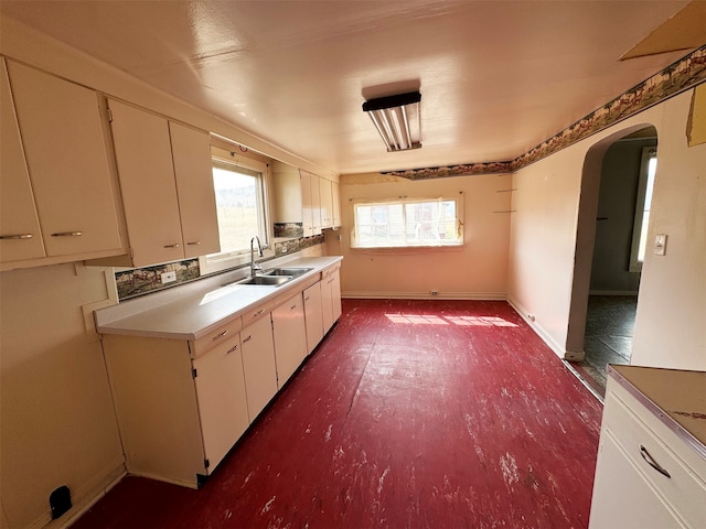 kitchen featuring white cabinetry and sink