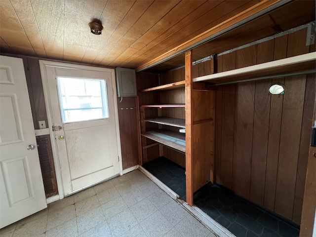 interior space with wood ceiling and wooden walls