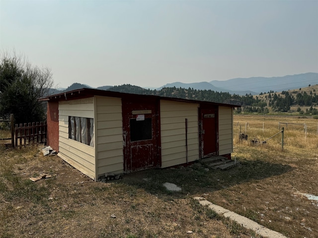 view of outbuilding featuring a mountain view and a rural view