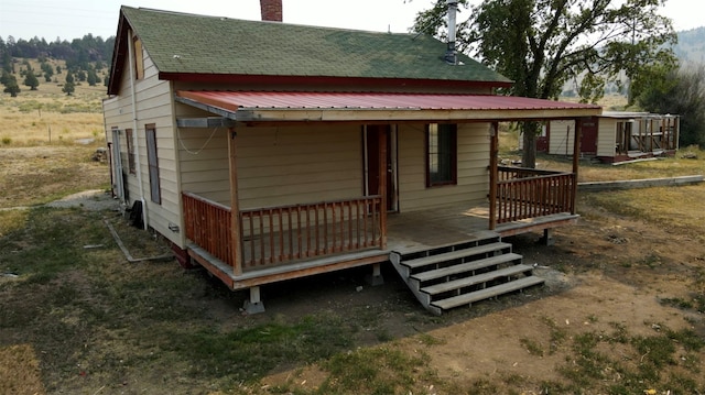 back of property with a wooden deck