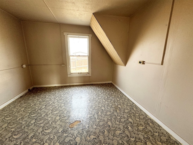 additional living space with a textured ceiling