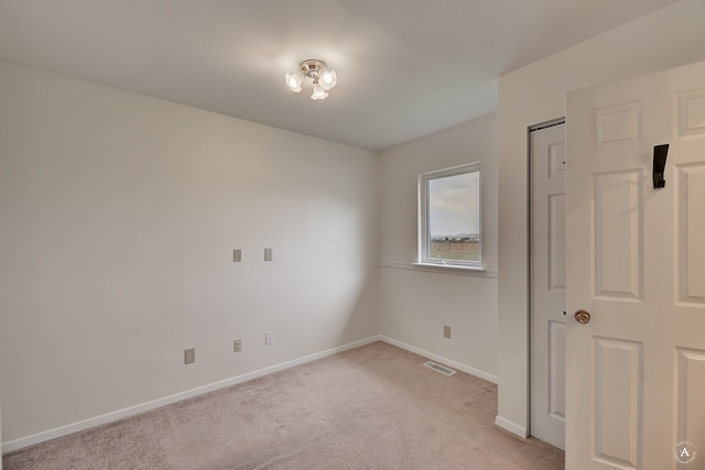 unfurnished bedroom with light colored carpet