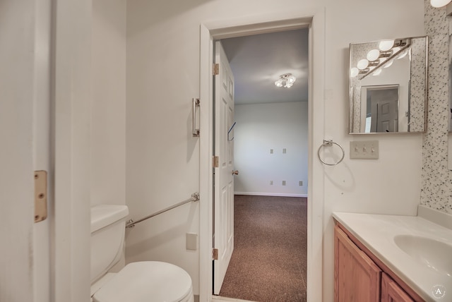 bathroom featuring toilet and vanity