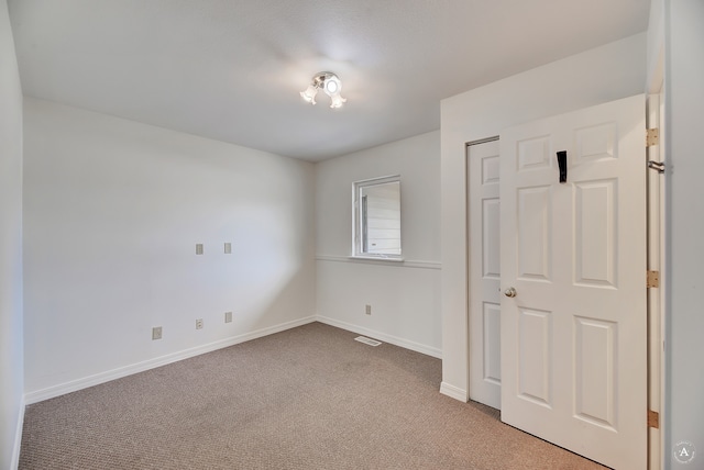 unfurnished bedroom with carpet floors