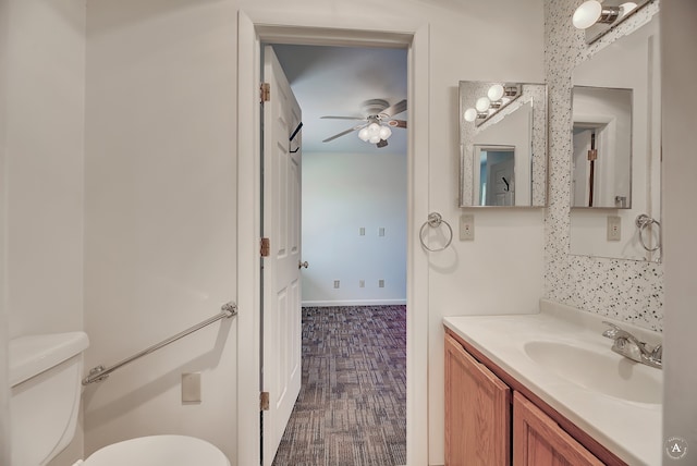 bathroom with vanity, toilet, and ceiling fan