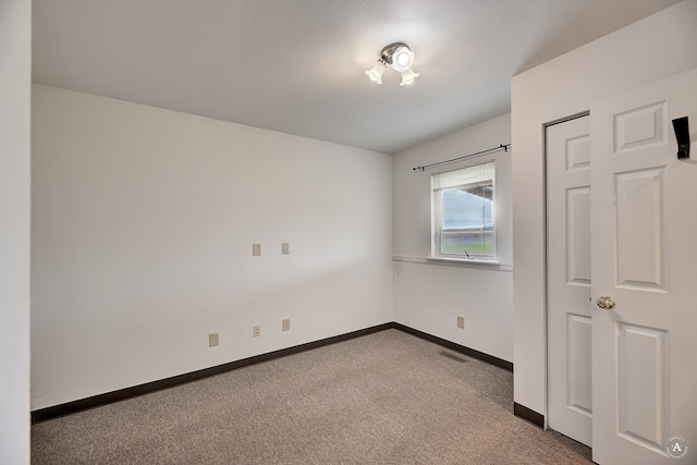 unfurnished bedroom featuring light carpet