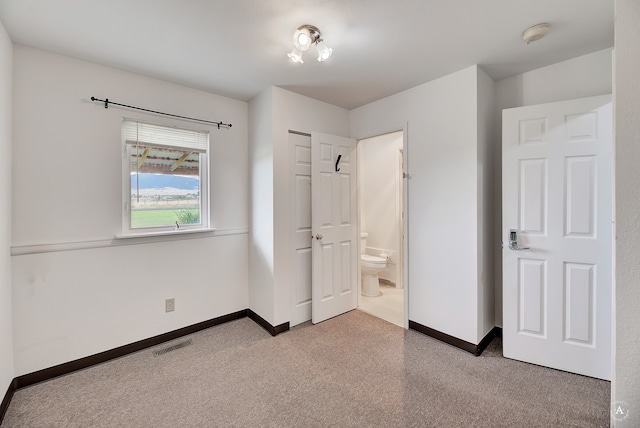 unfurnished bedroom featuring ensuite bath