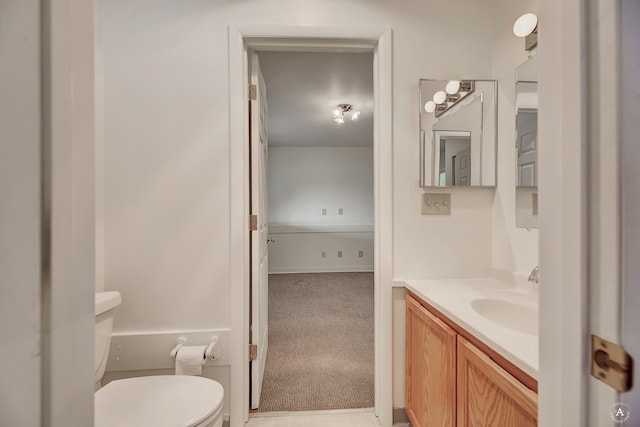 bathroom featuring toilet and vanity