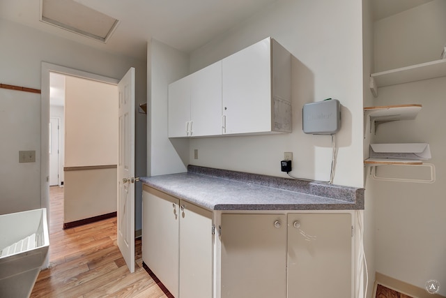 kitchen featuring white cabinets and light hardwood / wood-style floors