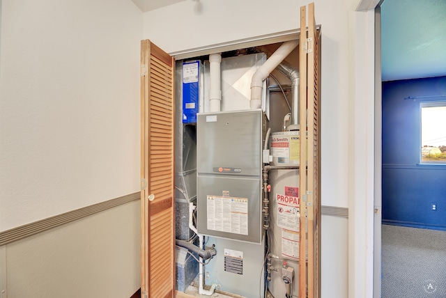 utility room featuring gas water heater