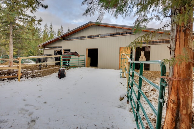 view of snow covered exterior with an outdoor structure