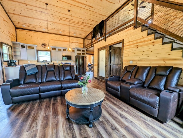 living room with wood walls, high vaulted ceiling, hardwood / wood-style flooring, and wooden ceiling