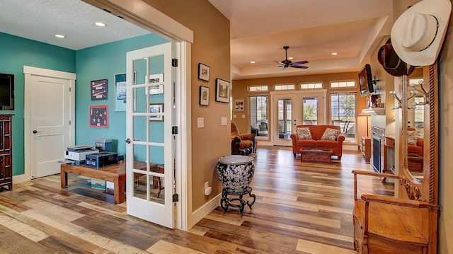 interior space featuring wood-type flooring, french doors, and a textured ceiling