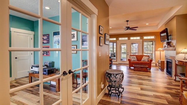 interior space featuring hardwood / wood-style floors, french doors, and a textured ceiling