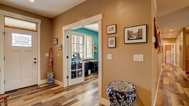 foyer entrance with plenty of natural light and light wood-type flooring