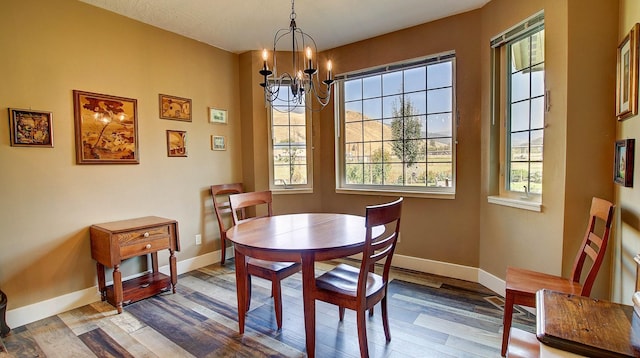 dining room featuring hardwood / wood-style floors and an inviting chandelier