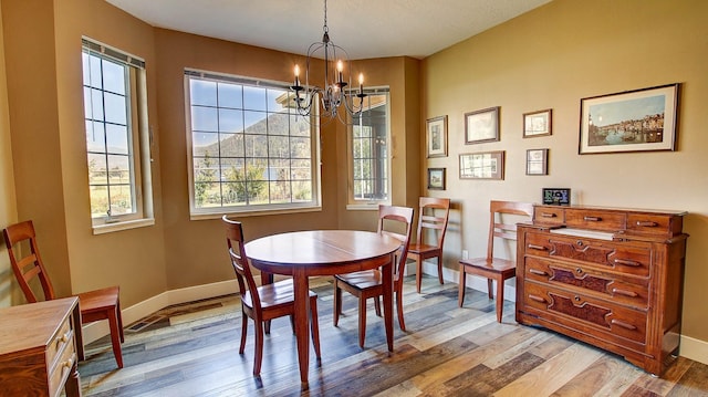 dining room with a chandelier and light hardwood / wood-style floors