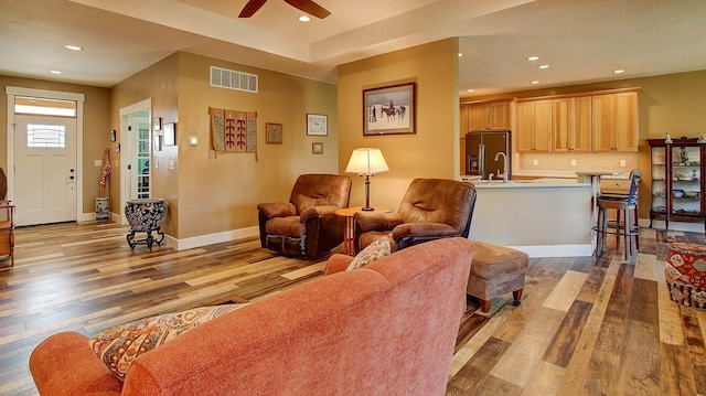 living room with hardwood / wood-style flooring and ceiling fan