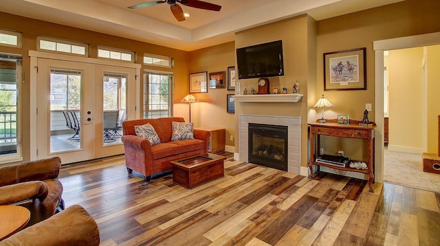 living room with french doors, ceiling fan, and hardwood / wood-style floors