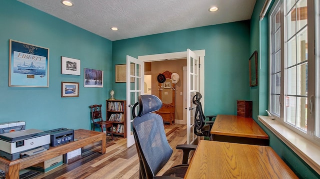 office featuring light hardwood / wood-style floors and a textured ceiling