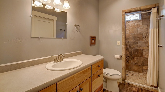 bathroom with vanity, wood-type flooring, toilet, and a shower with shower curtain