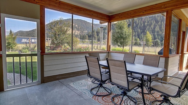 unfurnished sunroom featuring a mountain view