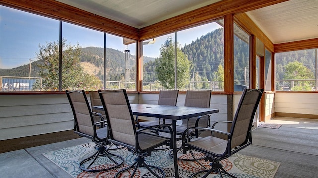 sunroom / solarium featuring a mountain view