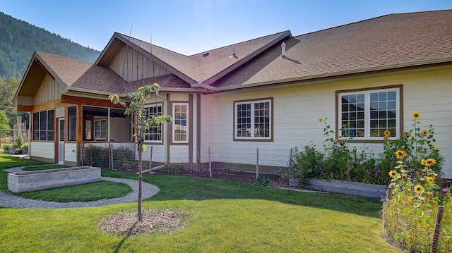 exterior space with a yard and a sunroom