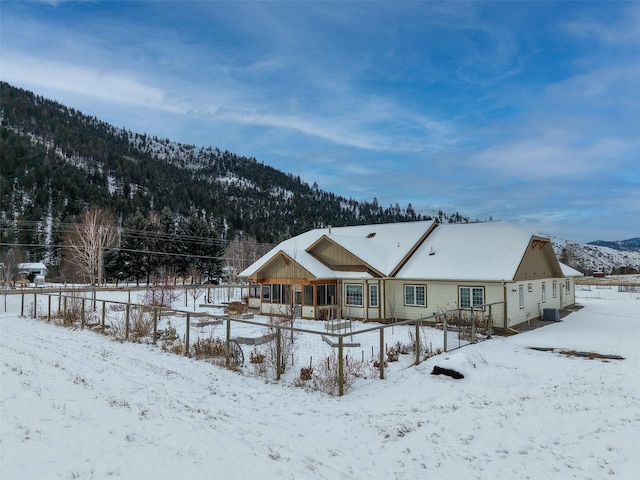 snow covered house with a mountain view