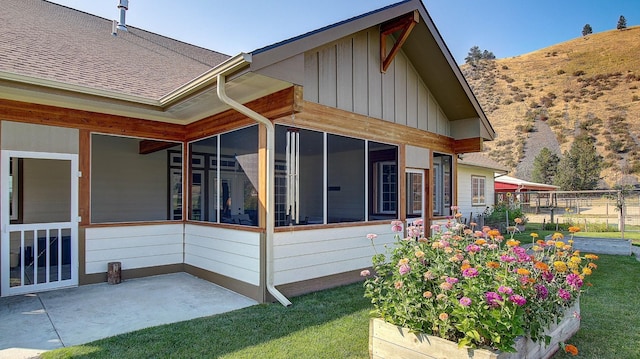 view of home's exterior featuring a patio and a sunroom