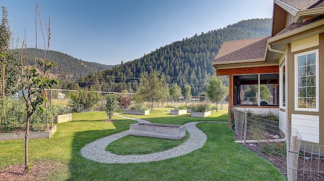 exterior space with a mountain view and a lawn