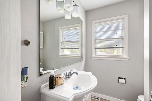 bathroom featuring toilet and sink