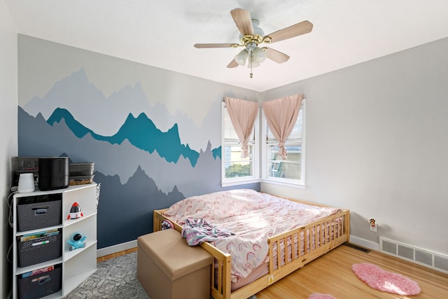 bedroom featuring hardwood / wood-style floors and ceiling fan