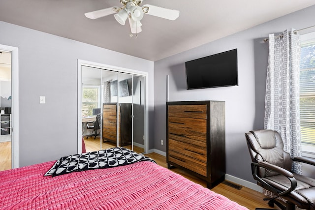 bedroom featuring hardwood / wood-style floors, ceiling fan, and a closet