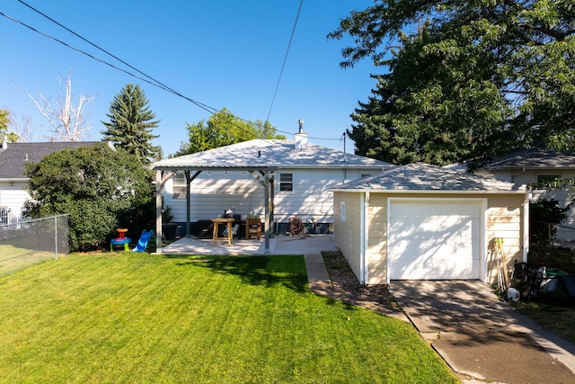 back of property featuring a garage, a patio area, a lawn, and an outbuilding