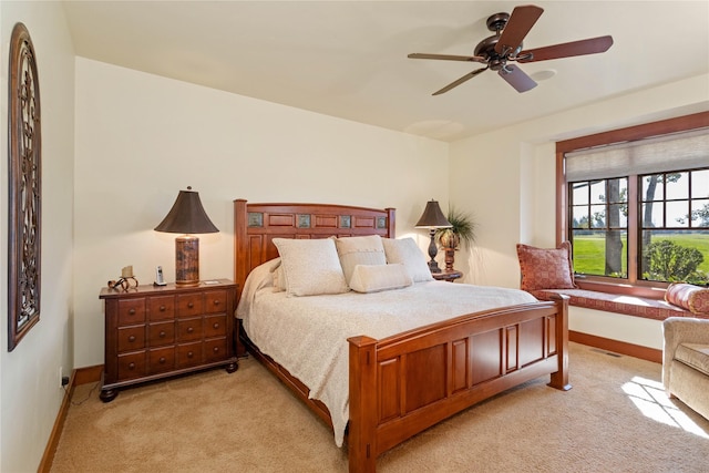 bedroom with light colored carpet, baseboards, ceiling fan, and visible vents