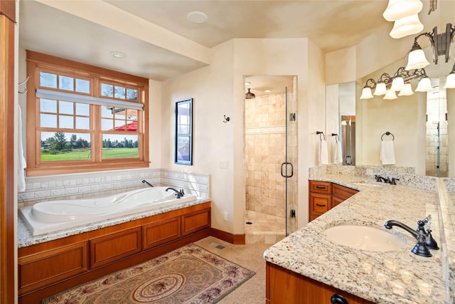 bathroom with a garden tub, baseboards, a stall shower, and vanity