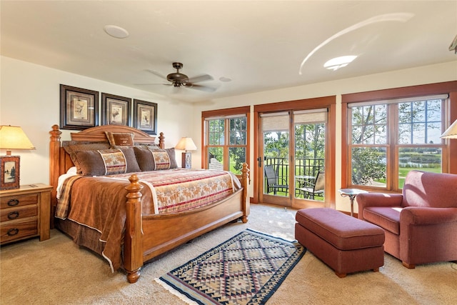 bedroom featuring light carpet, a ceiling fan, and access to exterior