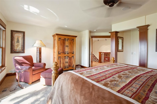 bedroom with carpet, a ceiling fan, baseboards, ornate columns, and visible vents
