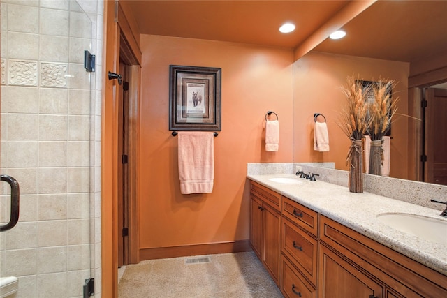 full bathroom featuring double vanity, recessed lighting, a sink, and a stall shower