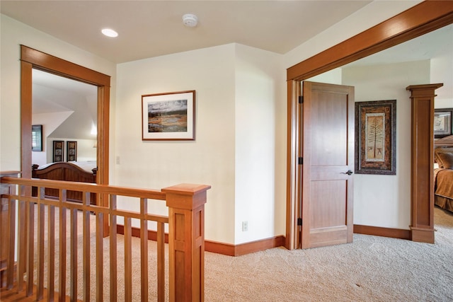 hallway with recessed lighting, baseboards, an upstairs landing, and carpet